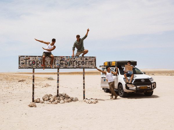 Tourists at the Tropic of Capricorn in Namibia with their Melbic 4×4 Car Rental vehicle Tourists at the Tropic of Capricorn in Namibia with their Melbic 4x4 Car Rental vehicle