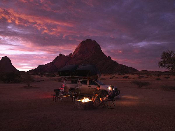 Tourists in from of their Melbic 4×4 Car Rental vehicle and enjoying their open fire Tourists in from of their Melbic 4x4 Car Rental vehicle and enjoying their open fire